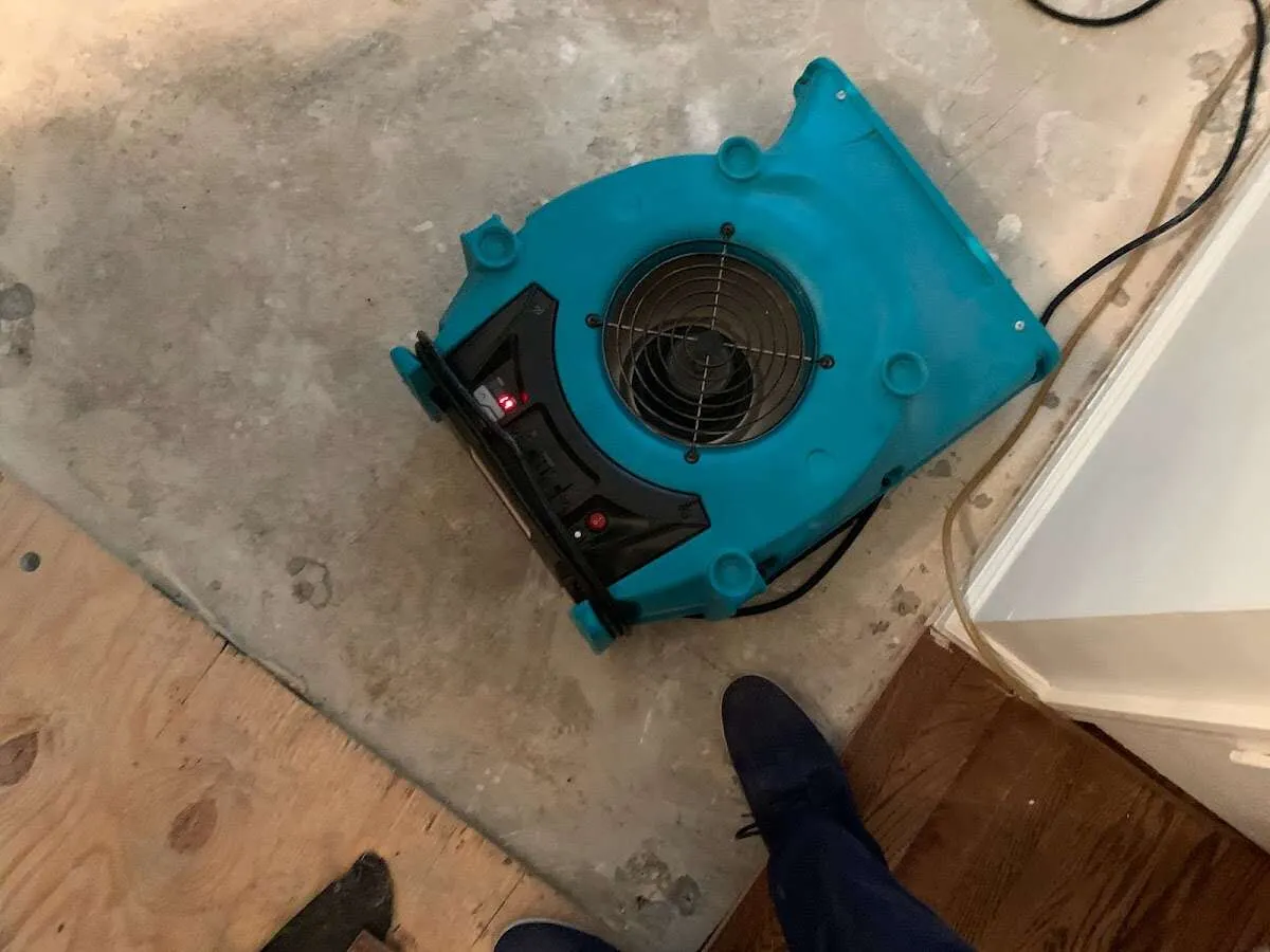 Air mover drying subfloor during Commercial Water Damage Restoration in Kendall West